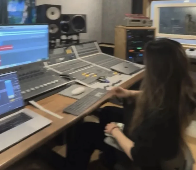 Anna working at a recording studio mixing console.